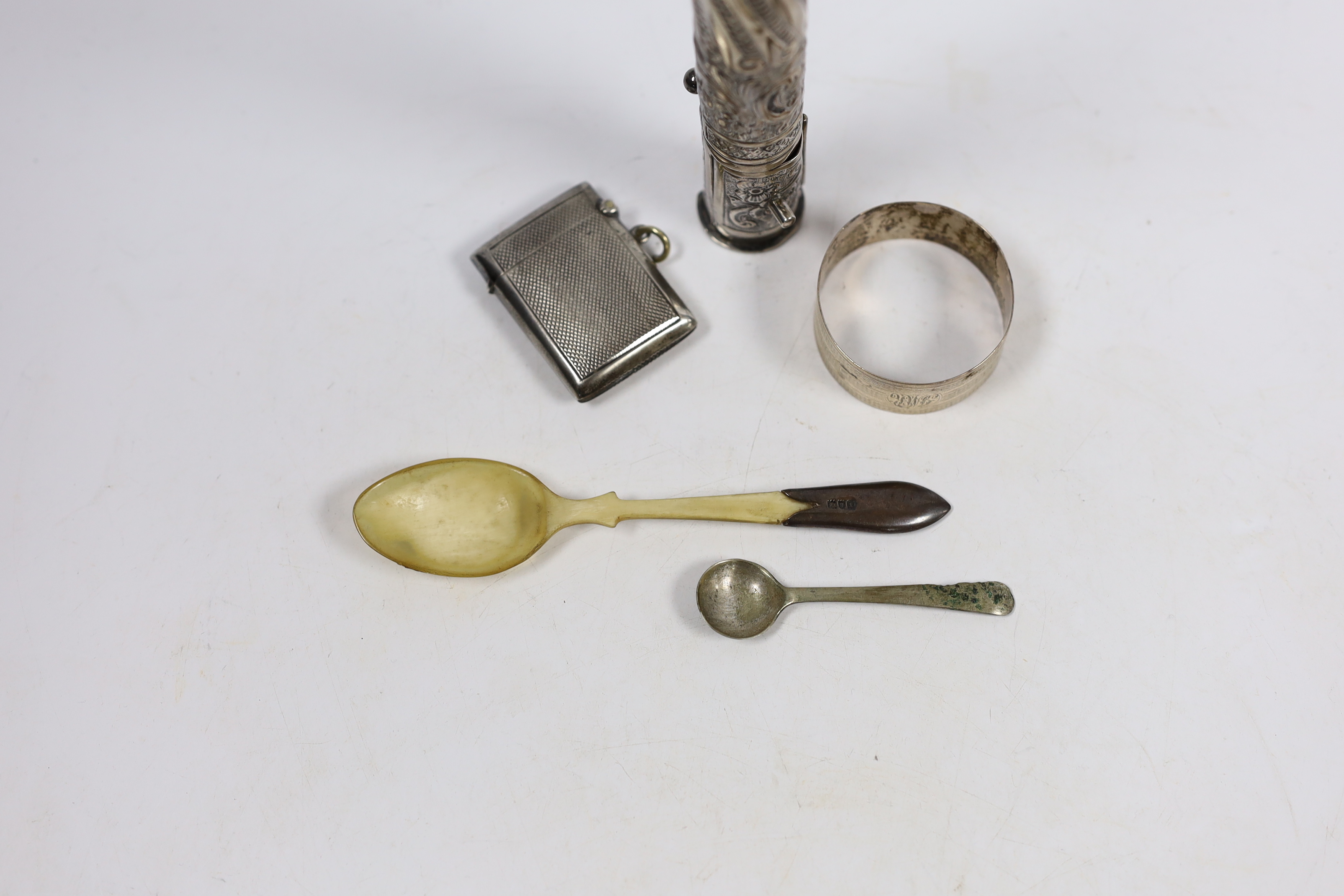 A late Victorian repousse silver sealing wax and match holder, with figural finial, Samuel Jacob, London, 1897, 20.7cm, a silver vesta case, two spoons and a silver napkin ring.